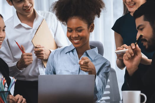 Happy diverse business people work together, discussing in corporate office. Professional and diversity teamwork discuss business plan on desk with laptop. Modern multicultural office worker. Concord