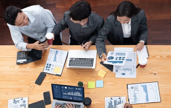 Top view multiracial analyst team use BI dashboard display on laptop screen, analyzing financial data for strategic decision. Fintech analyzes marketing indicators. Concord