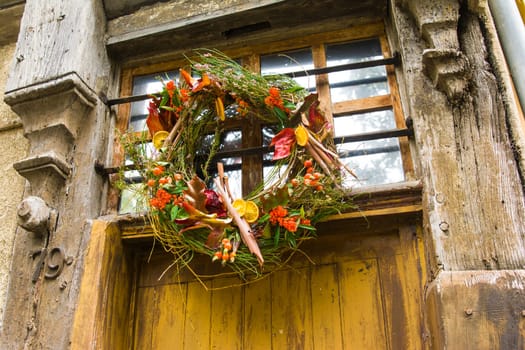 Wreath autumn or winter decoration on the shabby door
