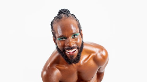 Smiling african-american bearded gay man with bright makeup isolated on white background. Exudes sense of pride and individuality. Diversity power of personality.