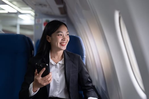 Beautiful Asian businesswoman working with laptop in aeroplane. working, travel, business concept.