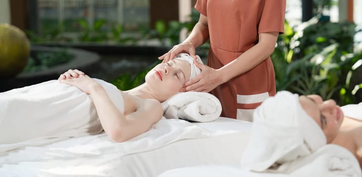 A portrait of two caucasian woman with beautiful skin having facial massage while falling the deep state of relaxation surrounded by outdoor natural and peaceful environment. Tranquility.