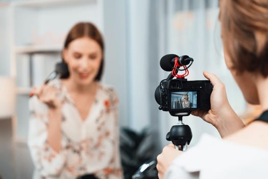 Woman influencer shoot live streaming vlog video review makeup utmost social media or blog. Happy young girl with cosmetics studio lighting for marketing recording session broadcasting online.