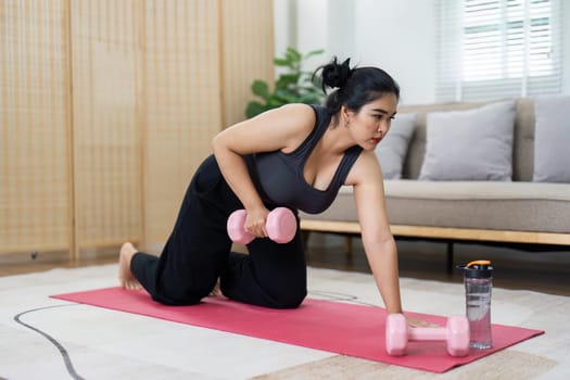 Cheerful attractive young overweight woman in activewear choosing healthy lifestyle.