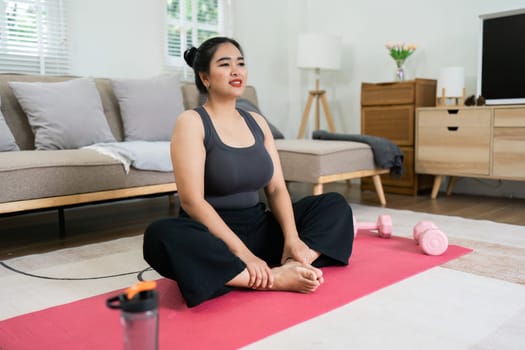 Cheerful attractive young overweight woman in activewear choosing healthy lifestyle.