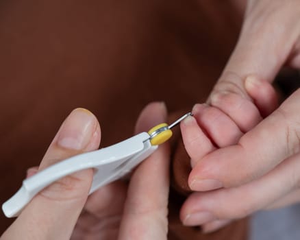 Mom cuts her newborn son's fingernails with small children's scissors