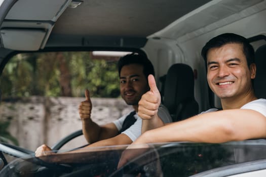 Truck driver and mover workers in uniform providing relocation service. Ethnically diverse team confidently delivering and unloading furniture. Transportation and teamwork shown. Moving Day Concept.