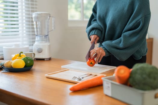 Fat woman cook in kitchen and chopping fresh vegetable on chopping board. health care concept Eat healthy food to lose weight.