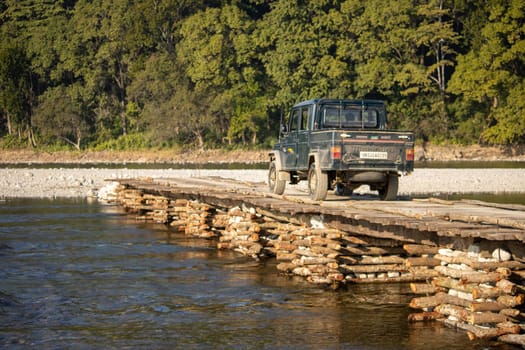 Gracefully suspended over the river, the beauty of a wooden bridge in Uttarakhand .High quality image