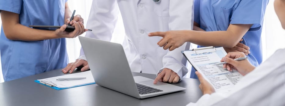 Doctor and nurse in medical meeting discussing strategic medical treatment plan together with report and laptop. Medical school workshop training concept in panoramic banner. Neoteric