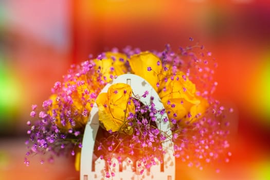 Bouquet of artificial flowers in orange-yellow gradient.