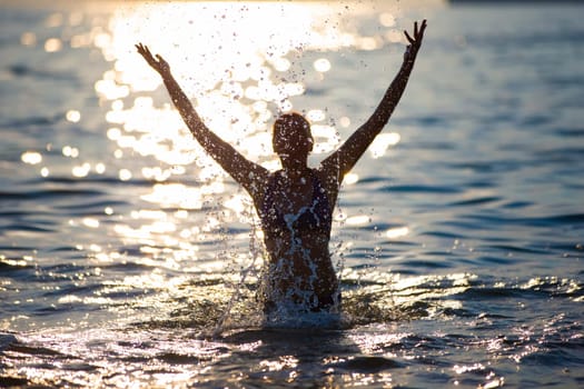 Silhouette of a woman with sea splashes.