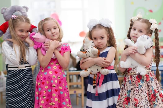 Belarus, Gomel, May 29, 2018. The kindergarten is central. Open Day.Girls preschool girls with soft toys in their hands.Girlfriends in kindergarten.Six-year-old girls