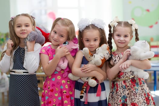 Belarus, Gomel, May 29, 2018. The kindergarten is central. Open Day.Girls preschool girls with soft toys in their hands.Girlfriends in kindergarten.Six-year-old girls