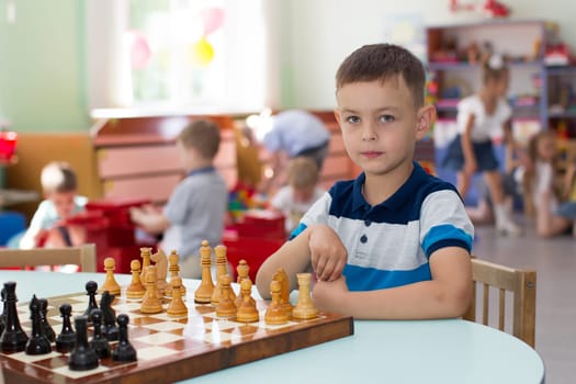 Belarus, Gomel, May 29, 2018. The kindergarten is central. Open Day.Boy playing chess in kindergarten