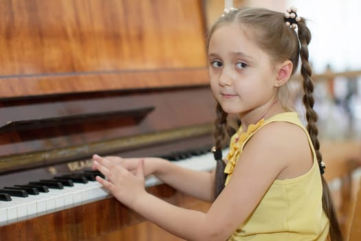 Belarus, Gomel, May 29, 2018. The kindergarten is central. Open Day.Child plays the piano.Preschool Music Education for Children