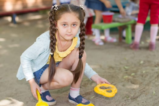 Belarus, Gomel, May 29, 2018. The kindergarten is central. Open Day.A preschool girl playing in the sand