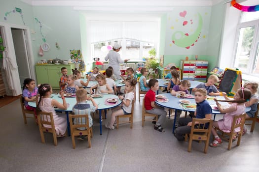 Belarus, Gomel, May 29, 2018. The kindergarten is central. Open Day.Many children in the kindergarten eat at the table.Lunch for children.