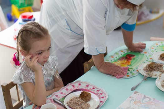 Belarus, Gomel, May 29, 2018. The kindergarten is central. Open Day.Lunch in the kindergarten. ?hild does not want to eat. Bad appetite. Eating in kindergarten