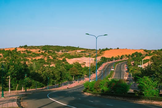 Highway curve road overpass nature landscape background dark tone mist day time street tall lanterns trees bushes sideway.