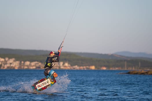 Gulbahce,Urla,Izmir,Turkey - July 30, 2023, People kite surf at the beach on a sunny afternoon in Gulbahce , Urla Izmir. High quality photo