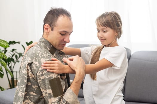 Military dad hugging his daughter. High quality photo