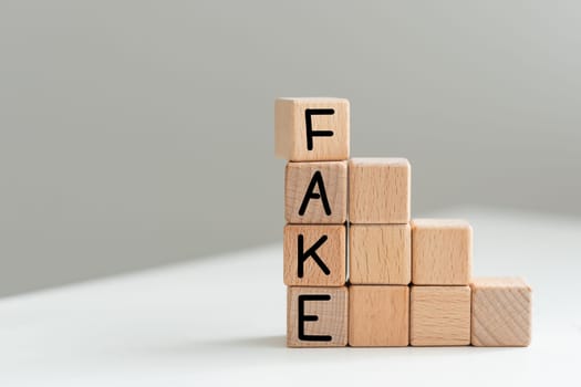 Fake news symbol. Wooden blocks with concept words Fake news on beautiful background from dollar bills. Business media and fake news concept. Copy space. High quality photo
