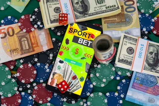 Mobile phone with bets, cards, chips, cubes and money dollars. Concept application for smartphone gambling, electronic casino online. High quality photo