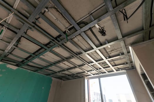 The metal frame of the ceiling, sound insulation, in the process of repairing an apartment. High quality photo