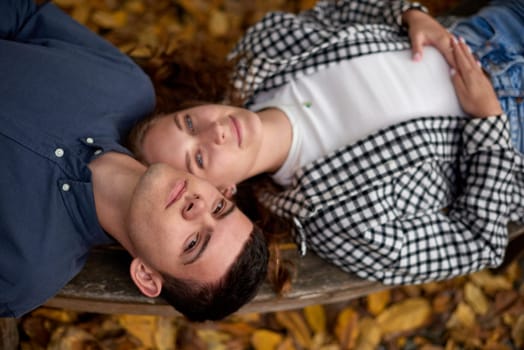 Young Cute Female Hugs Boyfriend. In Autumn Outdoor. Lovers Walking in Park. Attractive Funny Couple. Lovestory in Forest. Man and Woman. Cute Lovers in the Park. Family Concept. Happy Couple.