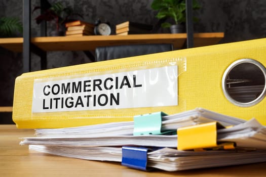 A yellow folder with commercial litigation documents.