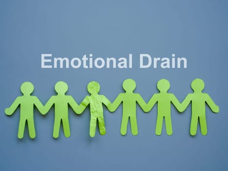 Emotional drain concept. Paper people and one crumpled one.