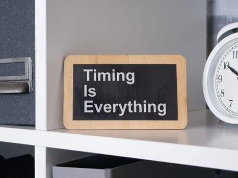 Timing is everything. Wooden sign with motivational quote.