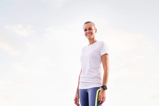 sports woman smiling happy looking at camera, concept of active and healthy lifestyle, copy space for text