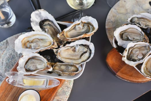 Fresh oysters with lemon on the plate