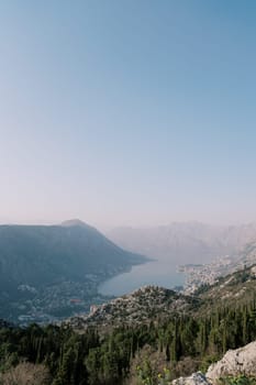 View from the mountain to the valley of the Bay of Kotor surrounded by mountains in a light haze. Montenegro. High quality photo