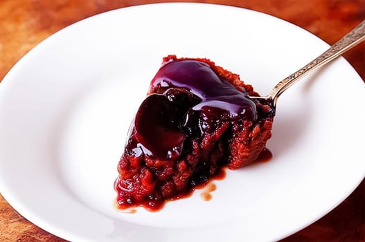 Christmas pudding, a piece of fruit pie on a plate with a fork. A traditional festive dessert. Plum Pudding Day.