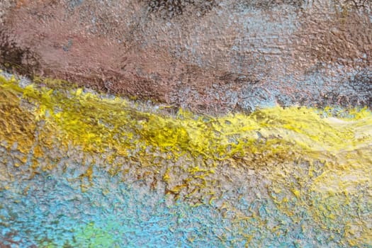 Bright texture of canvas painted in blue-yellow-brown colors with shades. Abstract background