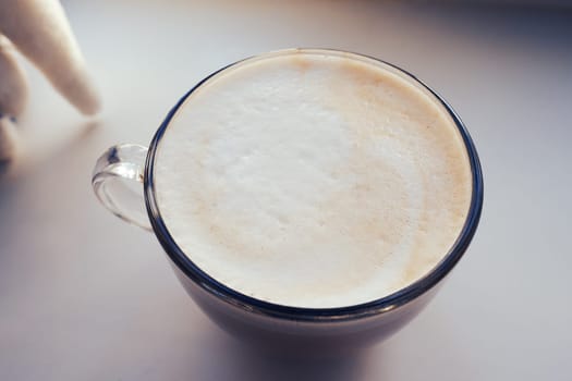 coffee poured into a large mug with foam