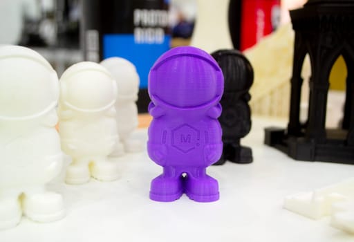 Object model printed on a 3D printer from purple molten plastic. 3D printer printed prototype of toy from plastic. 3D design and prototyping. Additive progressive new modern 3d printing technology