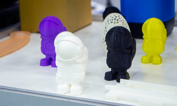 Abstract models printed on 3D printer. 3D printer created object from molten plastic. Modern three-dimensional printing technologies. 3D printer and 3D printing. Innovation additive robotic technology