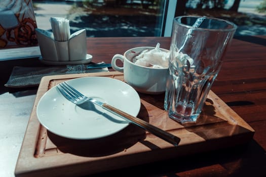 dirty dishes on a wooden tray. High quality photo