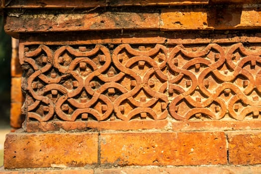 Terracotta patterns ancient stone carving, pattern on stone wall of Bagha Shahi Mosque