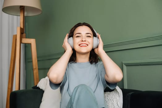 Rhythmic Relaxation. Woman Engrossed in Music for a Serene Weekend. Savoring Music Moments. Wireless Headphones Bring Weekend Joy to Woman.