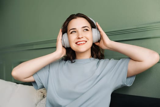 Chill and Melodies. Happy Young Woman Immersed in Weekend Music. Soothing Sounds. Woman in Wireless Headphones Enjoying Weekend Beats.