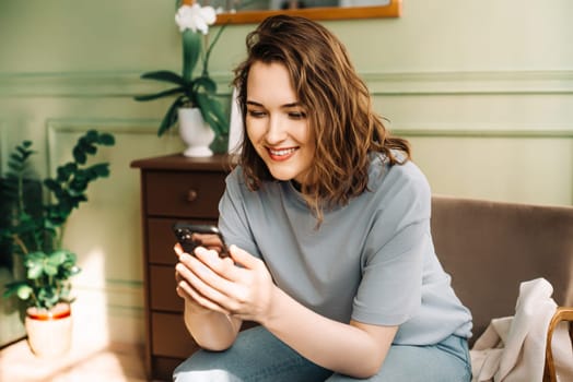 Social Media Enthusiast. Smiling Woman Engaged in Smartphone Chat. Digital Connection. Happy Woman Typing on Smartphone, Socializing. Enjoying Virtual Connections.