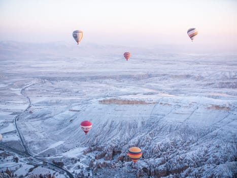 Colorful balloons over volcanic rocks in Cappadocia. Turkey