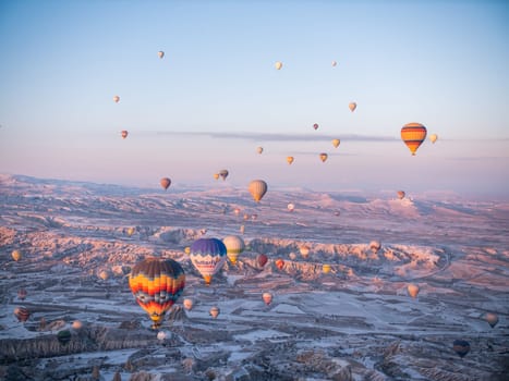 Colorful balloons over volcanic rocks in Cappadocia. Turkey