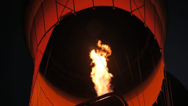 Inflating a balloon with fire. Cappadocia, Turkey