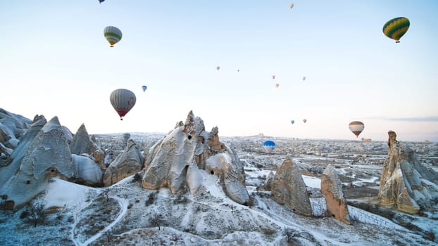 Colorful balloons over volcanic rocks in Cappadocia. Turkey